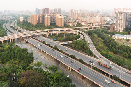 Car traffic on a flyover with residential buildings aerial viewのeditorial素材
