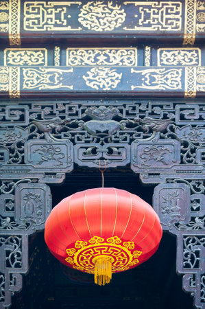 Red chinese lanterns hanging on a decorated door