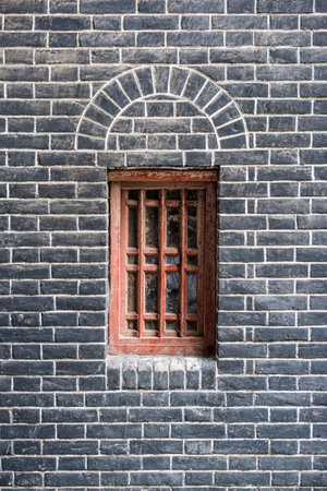 Small red window in a brick wallの写真素材