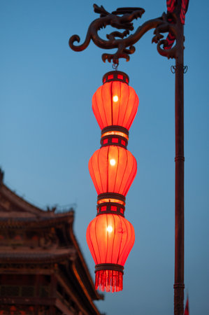 Illuminated red chinese lanterns on the fortified wall at night in Xi'an, Chinaの写真素材