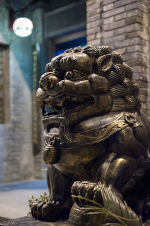 Lion bronze statue at night in a chinese street in Chengdu, Chinaの写真素材