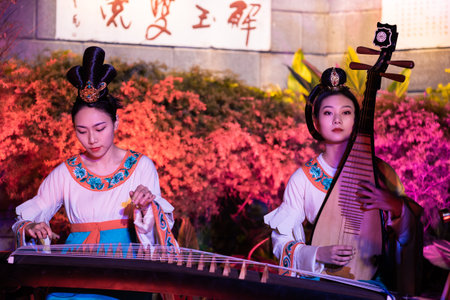 Chengdu, Sichuan province, China - Feb 5, 2019 : Chinese female musicians and dancers performing a public show at night at HeJiang pavilionのeditorial素材