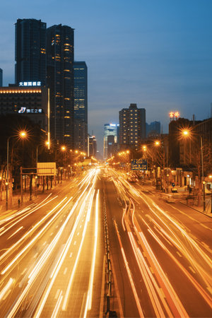 Chengdu, Sichuan province, China - Jan 14, 2016 : Traffic on an urban highway with car light trails at dusk in downtown Chengduのeditorial素材