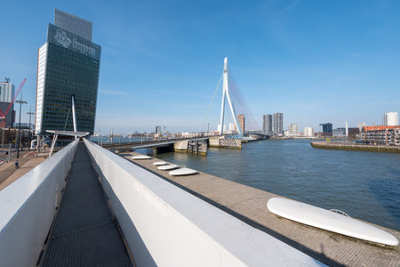 Rotterdam, Netherlands - March 26, 2016 : Erasmus bridge and KPN tower against blue sky and sunのeditorial素材
