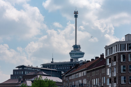 Rotterdam, Netherlands - April 29, 2019 : Euromast tower with traditional dutch buildings in the foreground against cloudy skyのeditorial素材