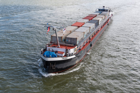 Rotterdam, Netherlands - May 9, 2019 : A small container ship on the new Meuse river aerial view