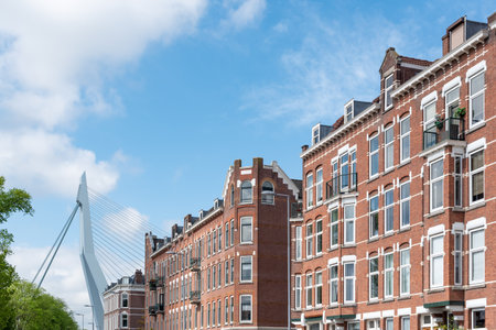 Rotterdam, Netherlands - May 9, 2019 : Dutch traditional buildings with erasmus bridge in the...