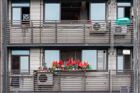 Chengdu, Sichuan province, China - Oct 14, 2019 : Chinese flags on an appartment balcony in downtown Chengdu for the chinese national holidaysのeditorial素材