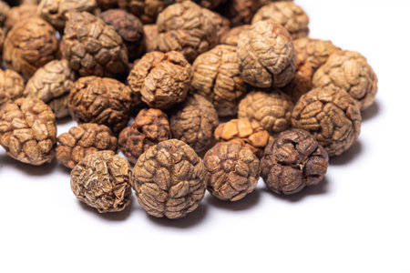Alpinia Hainanensis K Schum seeds fruits heap close-up view on white backgroundの写真素材