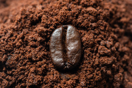 Coffee bean on ground coffee heap close up viewの写真素材