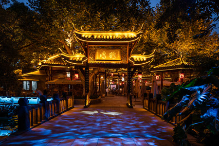 Chengdu, Sichuan province, China - Sept 18, 2021: Peoples park famous HeMing teahouse main gate illuminated at night. Chinese caracters on the gate meaning HeMing.のeditorial素材