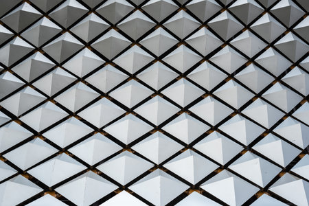 Metallic structure with geometric shapes on a building roof close-up viewの写真素材