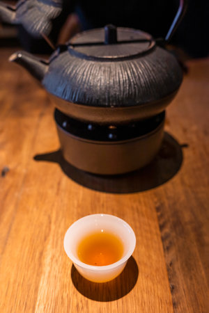 Cup of Chinese tea and teapot on a wooden table close-up viewの写真素材