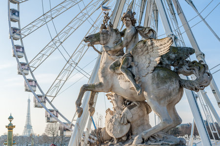 Place de la Concorde, Paris, France - Jan 8, 2018 : Perseus on Pegasus statue and Ferris wheel against blue skyのeditorial素材