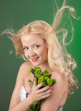Beauty blonde girl with green chrysanthemumの写真素材