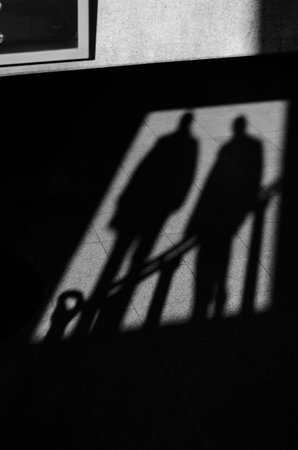 Shadow of two people on the floor providing a mysterious atmosphereの写真素材