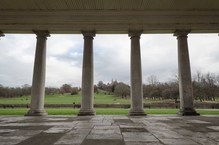 Panorama of a tunnel bordered by four Ionic-style columns overlooking the countryside