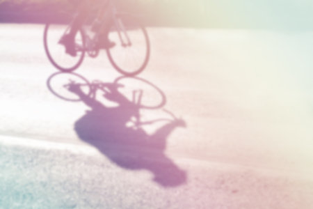 Abstract motion blur uette of cyclist on the street at sunrise, fill color filter pastel gradient tone.の写真素材