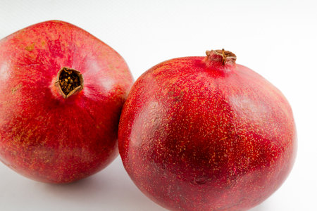 Two pomegranates on a white backgroundの写真素材