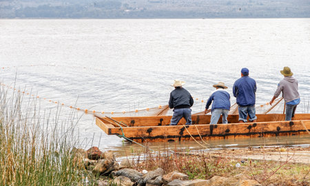Mexican fishermen pulling in their net on Lake Ptzcuaro, Mexico