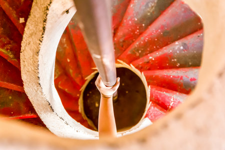 Handhold on the pole of a spiral staircaseの写真素材