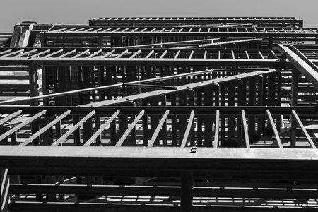Lines and geometrical forms created by a steel balcony and fire escape laddersの写真素材