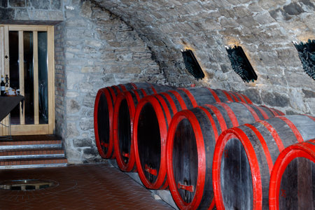 A row of wooden barrels in a wine cellarの写真素材