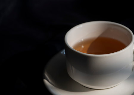 A cup of green tea in dark background.