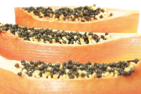 Slices of sweet papaya with seedsの写真素材
