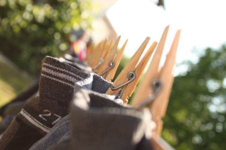 A wooden clothes-pin with others blurred.の写真素材
