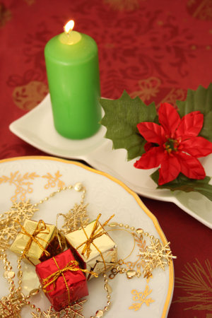 Christmas candle and decorations on a red background.の写真素材