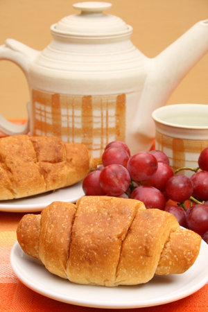 Croissant close up with some fruits and tea の写真素材