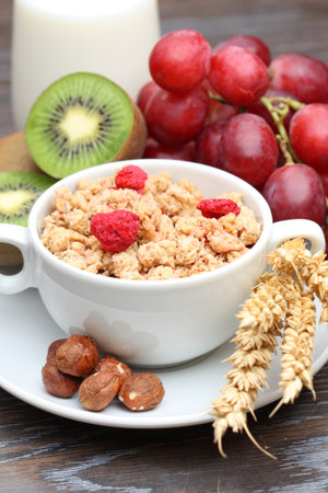 Healthy breakfast  muesli with grapes, kiwi, nuts and milk の写真素材