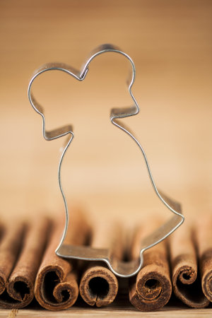 Cinnamon and christmas baking cutter on a brown background の写真素材