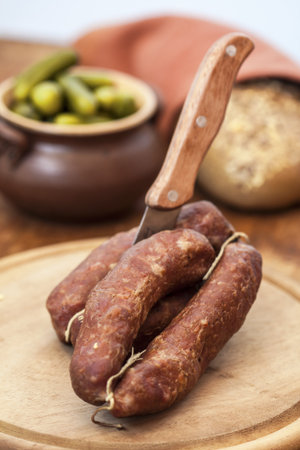 Sliced pork sausage on wooden table の写真素材