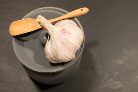 Jar with salt with a wooden spoon on slateの写真素材