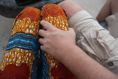 Mixed couple man with hand on ladies legの写真素材