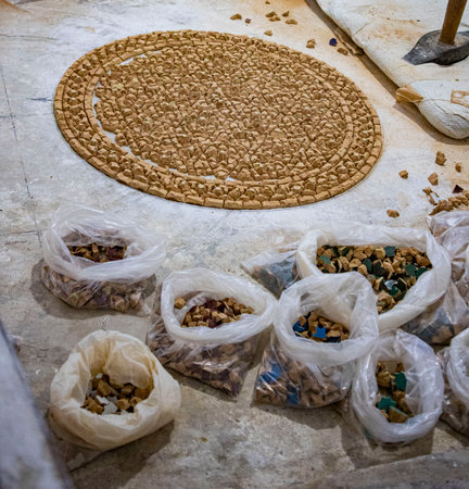 Each small piece of broken tile is a piece of the puzzle of this mosaic that will become a table.