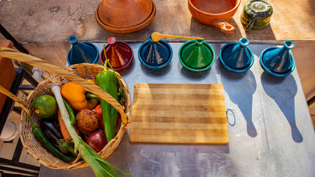 Fresh vegetables in a wicker basket on the table in the kitchenの写真素材