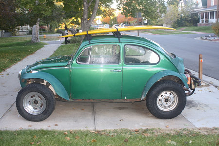 Vintage green car on the side of the road in the fallの写真素材