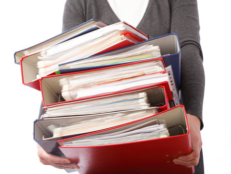 woman in grey holding stack of folders Pile with old documents and bills. Isolated on white backgroundの写真素材