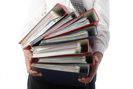 man holding stack of folders Pile with old documents and bills. Isolated on white backgroundの写真素材