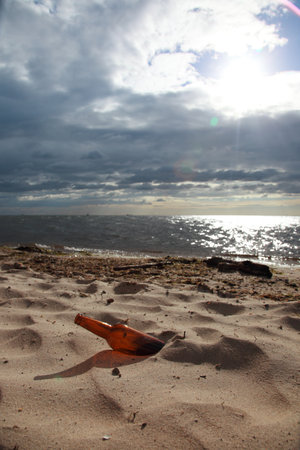 bottle on beach sea and skyの写真素材