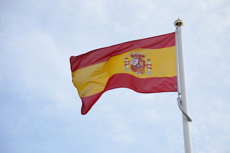 Spanish Flag of on blue sky background