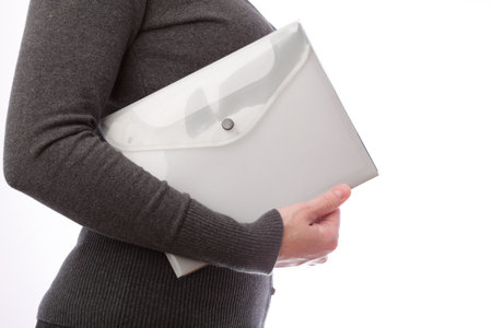 businesswoman in grey with folder, isolated on white の写真素材