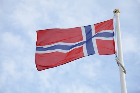 Norway flag of on blue sky backgroundの写真素材