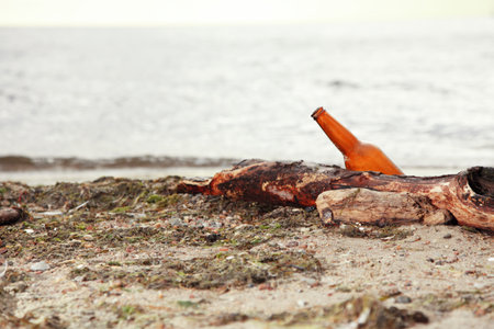 bottle on beach sea and skyの写真素材