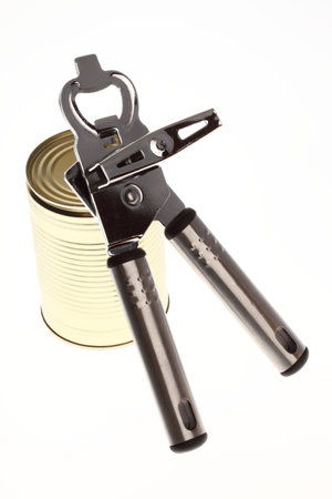 Tin opener opening a can of food isolated on white の写真素材