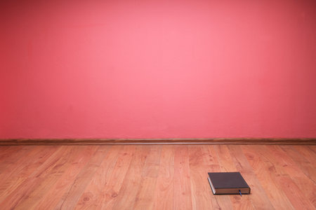 book to lie in floor red wall backgroundの写真素材
