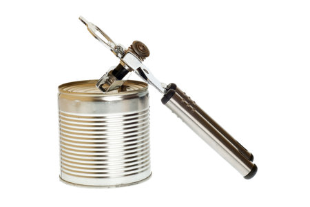 Tin opener opening a can of food isolated on white の写真素材